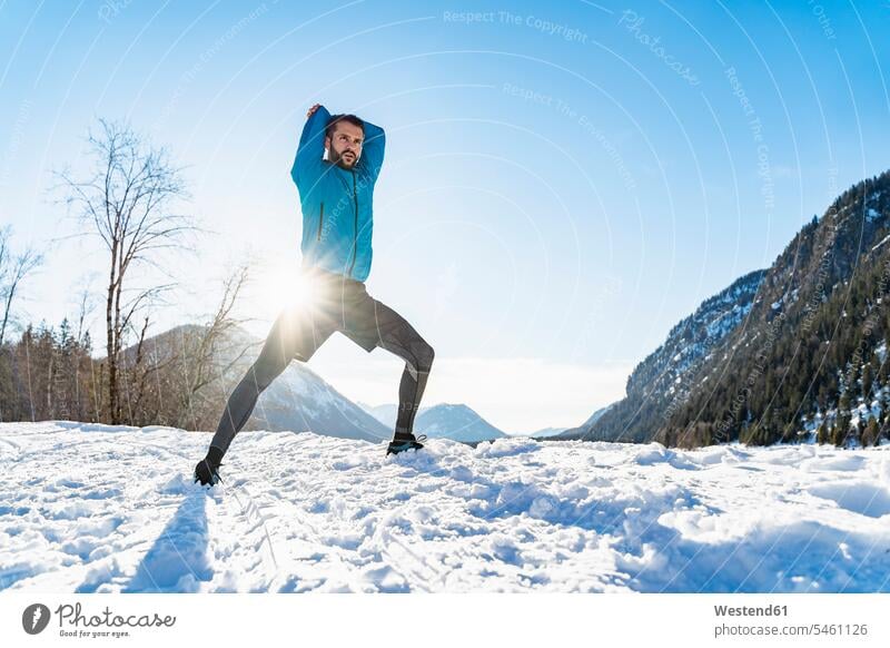 Germany, Bavaria, sportive man stretching in winter hibernal sporting sporty athletic men males sports Adults grown-ups grownups adult people persons