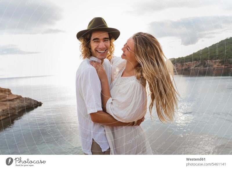 Portrait of young couple in love standing in front of the sea, Ibiza, Balearic Islands, Spain human human being human beings humans person persons