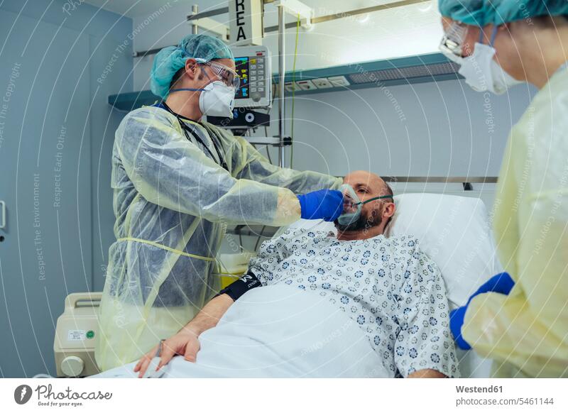 Doctors caring for patient in emergency care unit of a hospital with respiratory equipment colleague health healthcare Healthcare And Medicines medical medicine