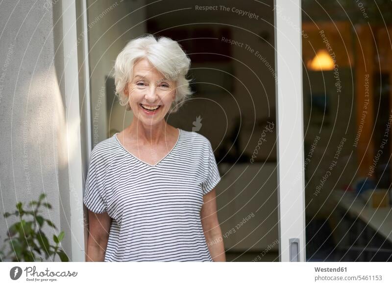 Portrait of laughing mature woman standing in front of opened terrace door in the evening T- Shirt t-shirts tee-shirt delight enjoyment Pleasant pleasure happy