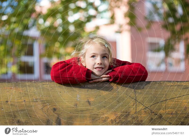 Portrait of blond little girl leaning on wooden railing Railing Railings blond hair blonde hair portrait portraits females girls people persons human being