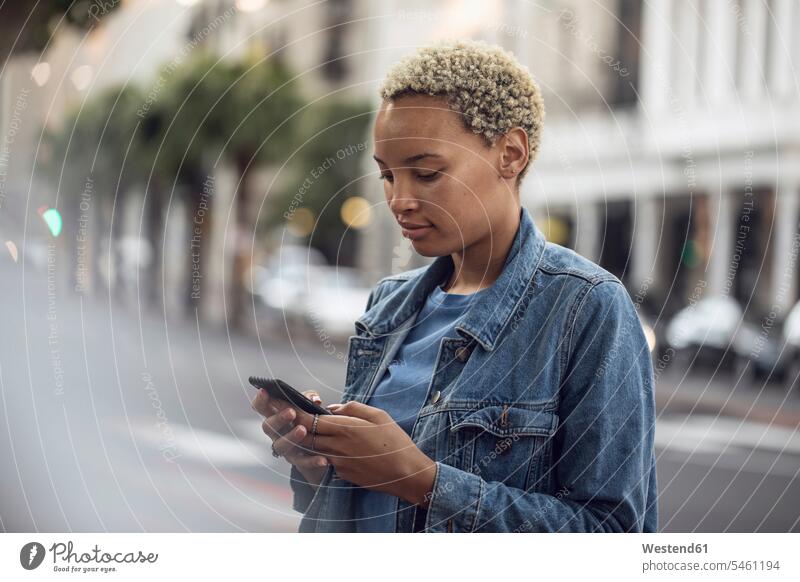 Young woman using smartphone in the city human human being human beings humans person persons African black black ethnicity coloured Afro European 1