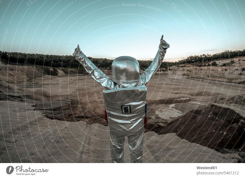 Spaceman raising arms on a nameless planet, with thumbs up astronaut astronauts unknown planets Exploration exploring explore spaceman spacemen astronautics