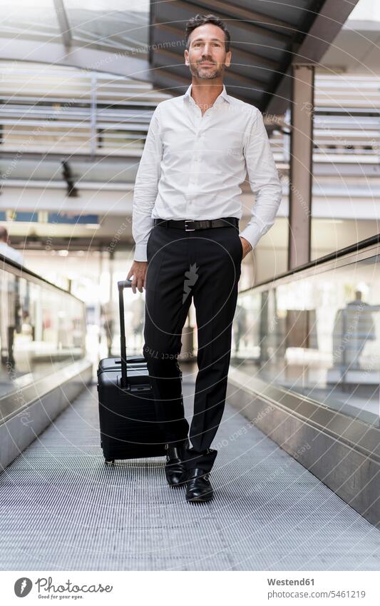 Businessman on moving walkway at the airport human human being human beings humans person persons caucasian appearance caucasian ethnicity european 1