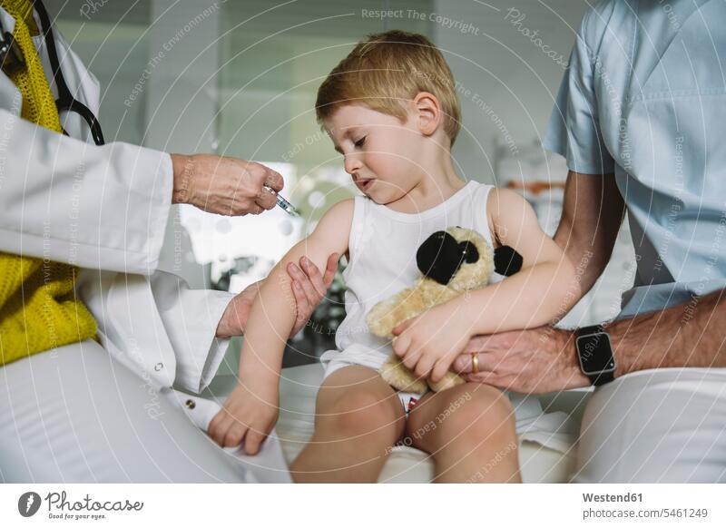 Pediatrist injecting vaccine into arm of unhappy toddler health healthcare Healthcare And Medicines medical medicine disease diseases ill illnesses sick