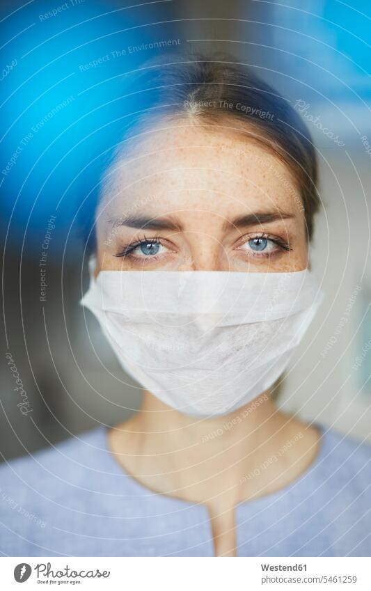 Portrait of woman wearing surgical mask females women portrait portraits Adults grown-ups grownups adult people persons human being humans human beings