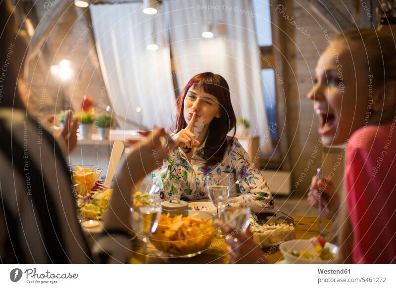 Happy female friends having dinner at home together eating Dinner Evening Meals Dinners Supper Suppers happiness happy Food foods food and drink Nutrition