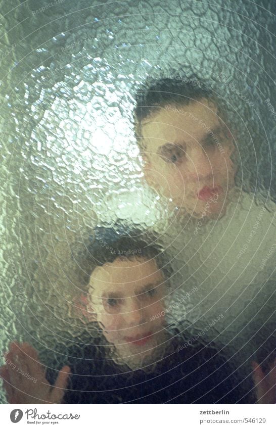 Brothers T. and P. from B. Child Boy (child) Brothers and sisters Son Glass Window pane Slice Ribbed glass Glass door Door Blur Unclear Data protection Looking
