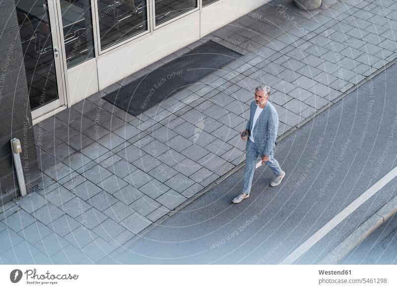 Top view of mature businessman walking on a road human human being human beings humans person persons caucasian appearance caucasian ethnicity european 1