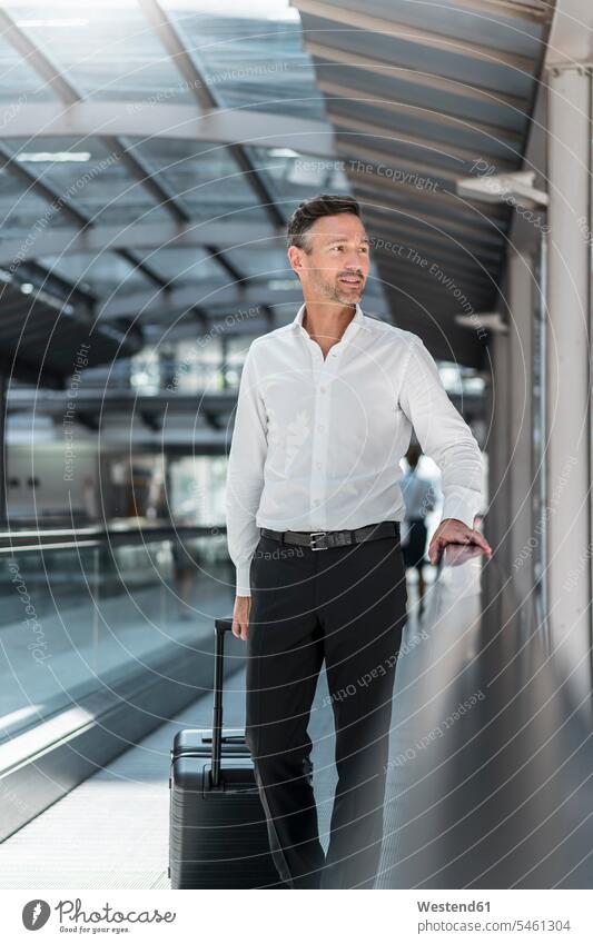 Businessman on moving walkway at the airport human human being human beings humans person persons caucasian appearance caucasian ethnicity european 1