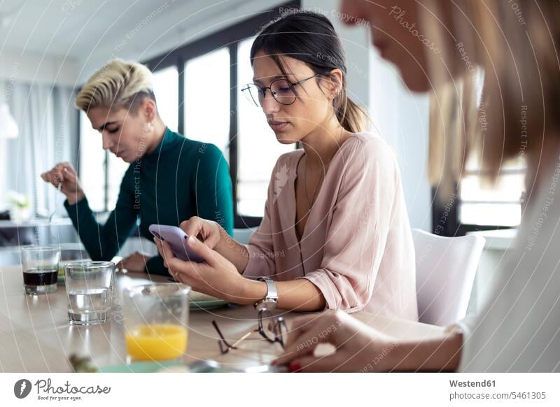 Businesswoman using smartphone during lunchtime at the office Occupation Work job jobs profession professional occupation business life business world
