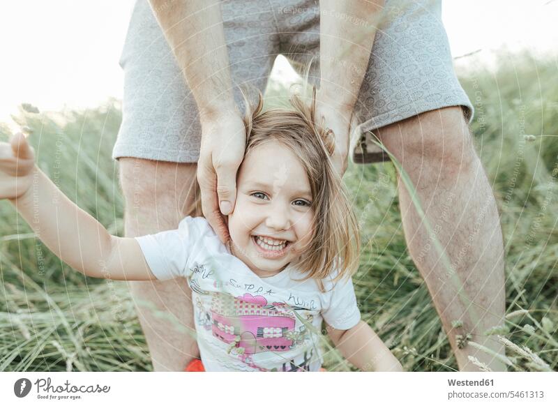 Portrait of happy little girl with father in nature pa fathers daddy dads papa portrait portraits happiness females girls natural world parents family families