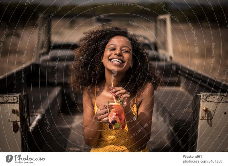 Portrait of laughing woman drinking fresh ice tea drink at safari bus human human being human beings humans person persons African black black ethnicity