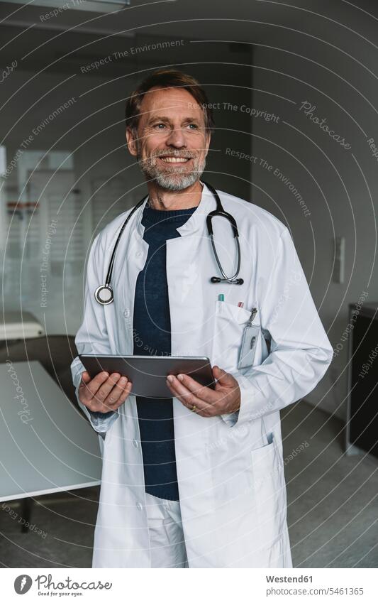 Portrait of smiling doctor holding tablet human human being human beings humans person persons caucasian appearance caucasian ethnicity european 1