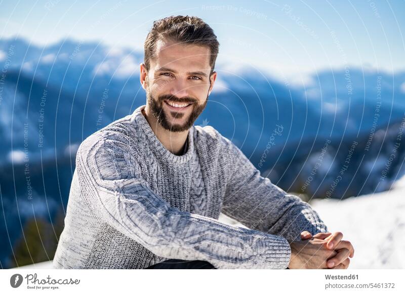 Germany, Bavaria, Brauneck, portrait of smiling man in winter in the mountains smile hibernal portraits men males mountainscape mountainscapes mountain scenery