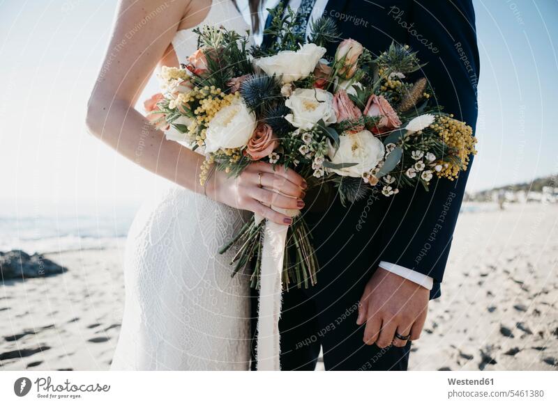 Bridal couple with bridal bouquet at the beach human human being human beings humans person persons marriage matrimony married couples bridal couple