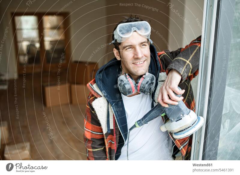 Portrait of a handyman renovating flat flats apartment apartments confidence confident worker blue collar worker workers blue-collar worker portrait portraits