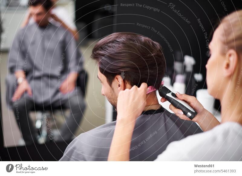 Hairdresser cutting man's hair hair salon hair salons men males female hairdresser people persons human being humans human beings crafts enterprise