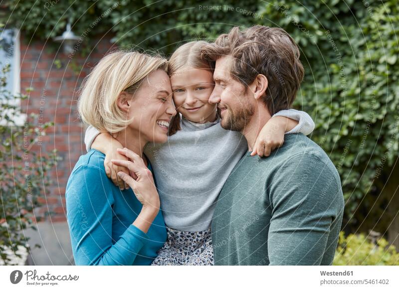 Portrait of happy family in garden of their home happiness families portrait portraits gardens domestic garden at home house houses people persons human being