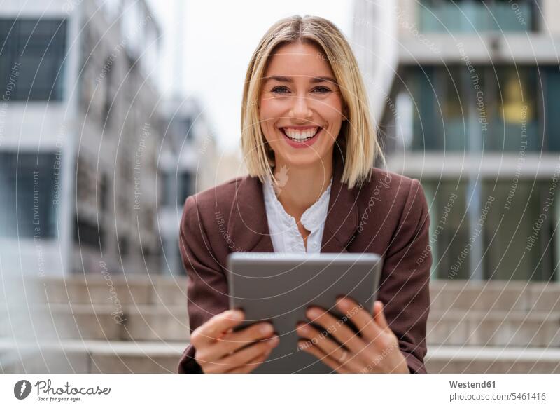Portrait of happy young businesswoman using tablet in the city human human being human beings humans person persons caucasian appearance caucasian ethnicity