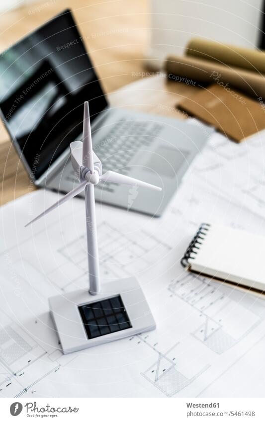 Wind turbine model, construction plan and laptop on table in office documents paper papers architectural drawing Blueprints Building Plan Construction Plan