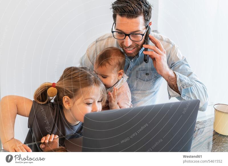 Father talking over smart phone with daughters by his side at home color image colour image indoors indoor shot indoor shots interior interior view Interiors