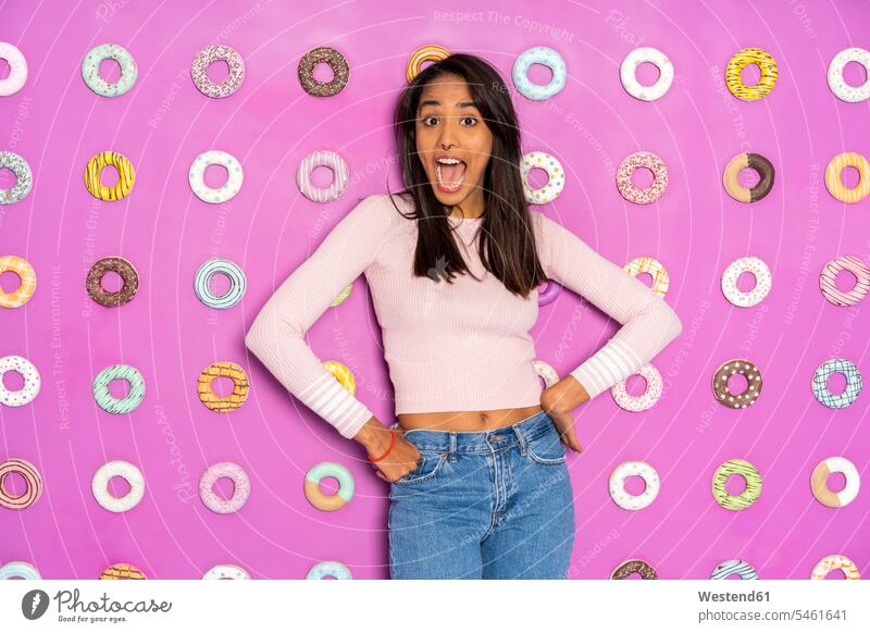 Young woman screaming at an indoor theme park with donuts at the wall one person 1 one person only only one person mouth open open mouth nonconformity posing