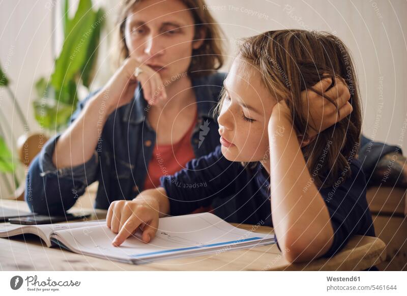 Father assisting son in doing homework at home color image colour image indoors indoor shot indoor shots interior interior view Interiors day daylight shot