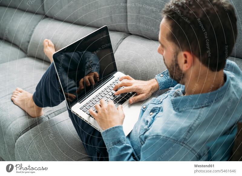 High angle view of businessman using laptop while working from home during coronavirus pandemic outbreak, Almeria, Spain, Europe color image colour image