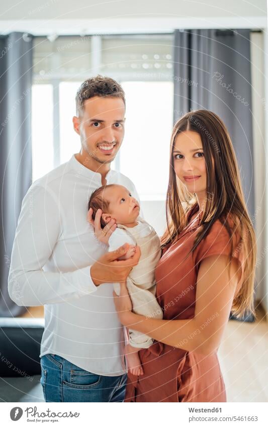 Happy parents carrying baby boy at home color image colour image indoors indoor shot indoor shots interior interior view Interiors day daylight shot