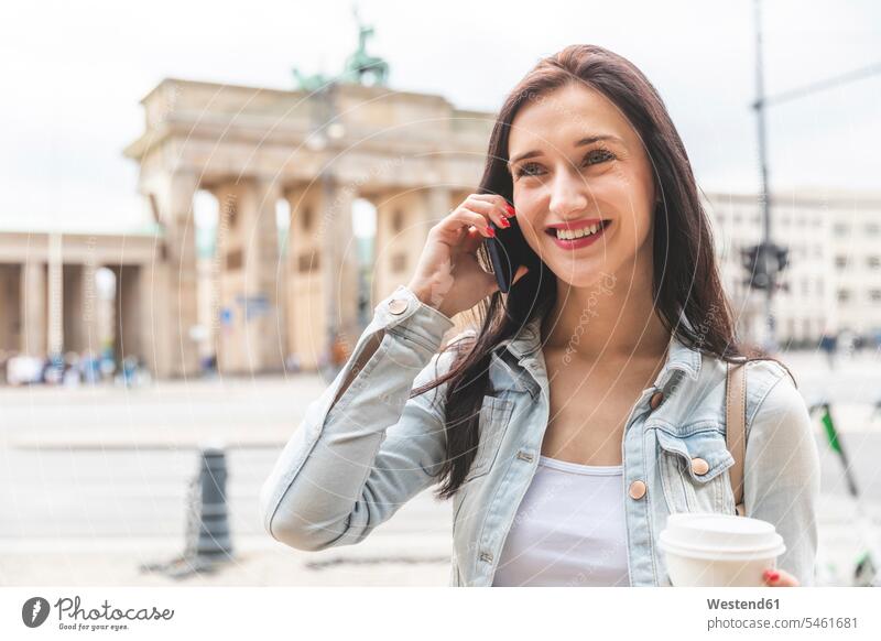 Happy young woman on the phone at Brandenburg Gate, Berlin, Germany human human being human beings humans person persons caucasian appearance