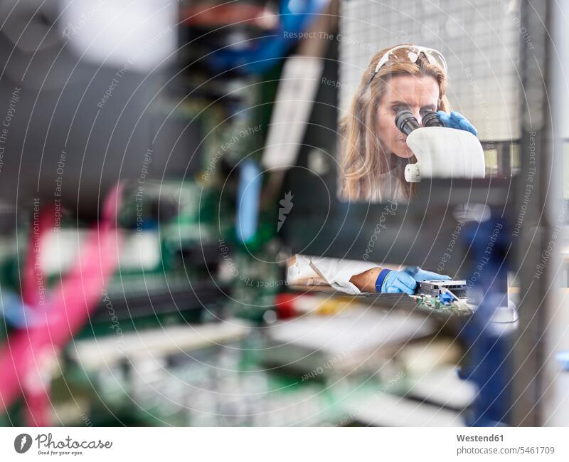 Female technician working with microscope in research laboratory engineer female engineer engineers female engineers At Work circuit board circuit boards