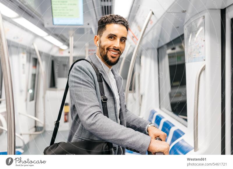 Portrait of smiling young businessman with earphones on the subway business life business world business person businesspeople Business man Business men
