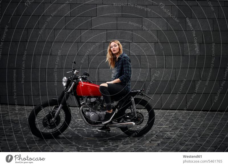 Portrait of confident young woman on motorcycle motorbike Motor Cycle portrait portraits confidence females women motor vehicle road vehicle road vehicles