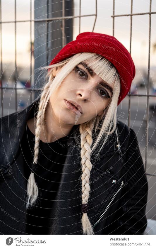 Portrait of young woman with blond braids wearing red woolly hat human human being human beings humans person persons caucasian appearance caucasian ethnicity