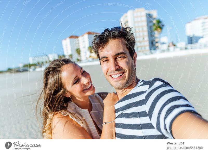 Selfie of a happy young couple on the beach happiness twosomes partnership couples Selfies beaches people persons human being humans human beings resort