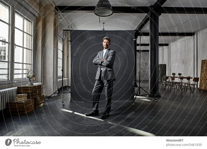 Portrait of mature businessman in front of black backdrop in loft Backdrop Businessman Business man Businessmen Business men portrait portraits lofts