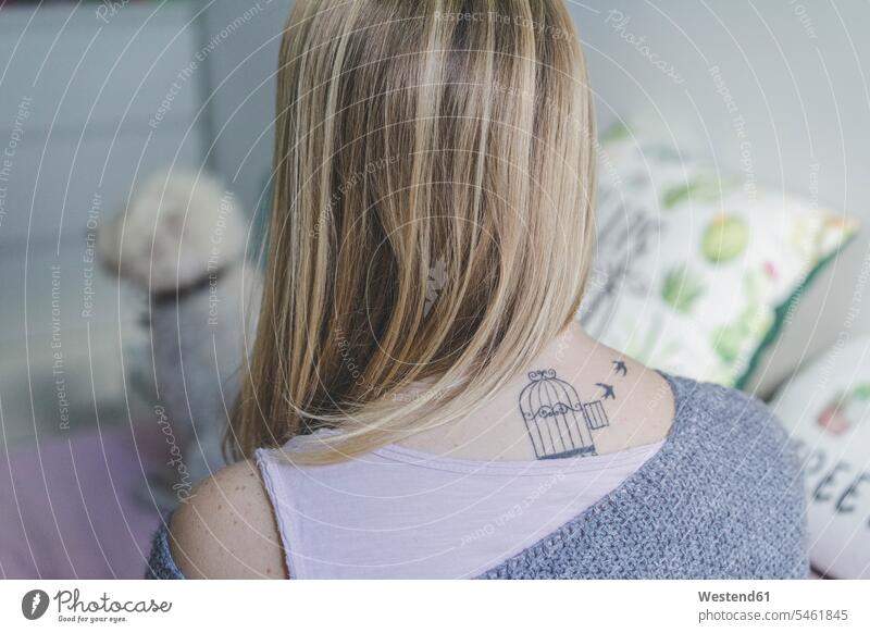 Back view of blond woman with tattoo on her neck nape females women tattoos Adults grown-ups grownups adult people persons human being humans human beings image