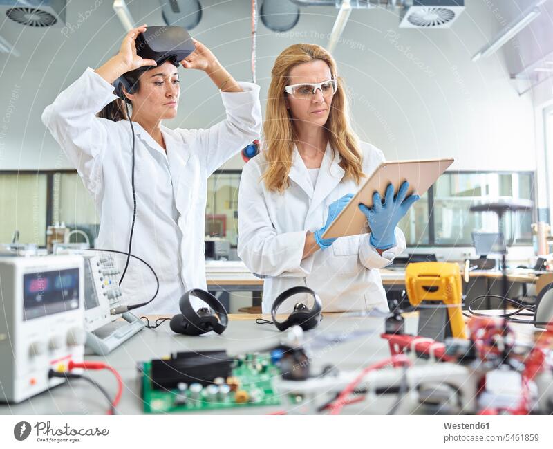 Female technicians working with tablet and vr glasses virtual reality VR female technician female technicians female researcher engineer female engineer