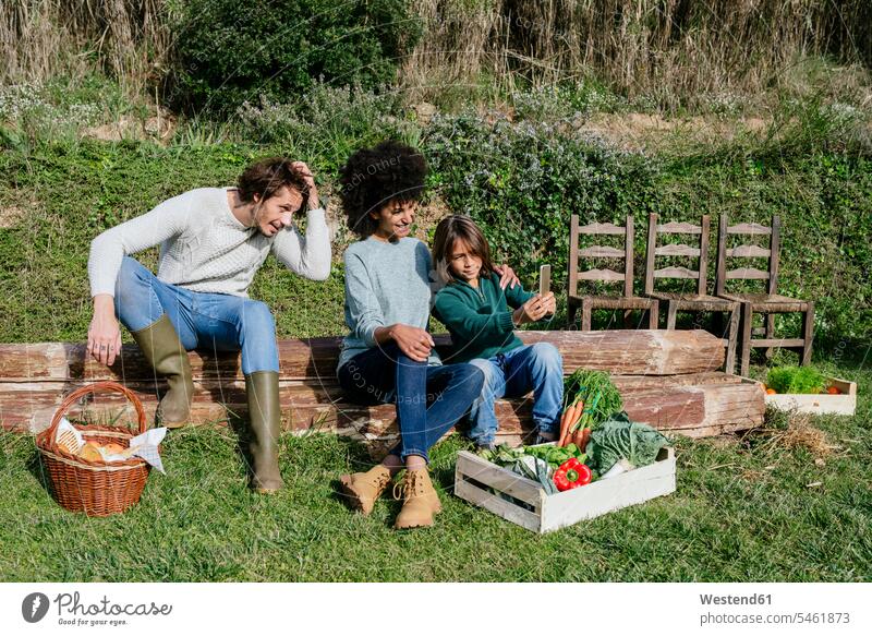 Happy family taking a break after harvesting vegetables, taking selfies Picnic picnicking Vegetable Vegetables Taking a Break resting Selfie Selfies