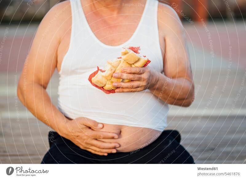 Man with beer belly holding sandwich human human being human beings humans person persons celibate celibates singles solitary people solitary person touch