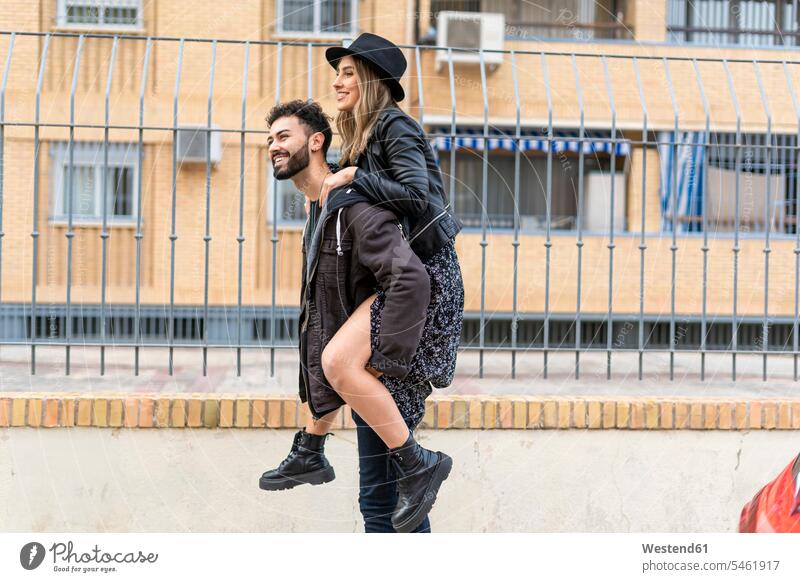 Young man giving his girlfriend a piggyback ride human human being human beings humans person persons caucasian appearance caucasian ethnicity european 2