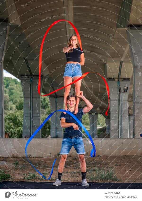 Young couple doing acrobatics with fitness band human human being human beings humans person persons caucasian appearance caucasian ethnicity european 2