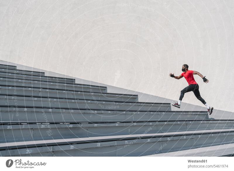 Sportsman wearing face mask running up stairs exercise practising train training colour colours sports athletes Sports Person Sportsmen Sportspeople