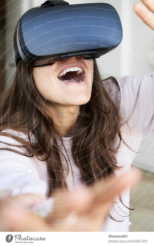 Young woman having fun using virtual reality headsets at home use interactive interactivity Virtual Reality Glasses VR glasses Virtual-Reality Glasses