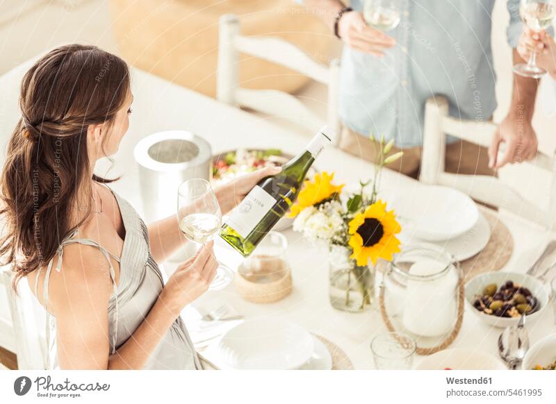 Woman holding wine bottle during lunch Bottles wine bottles Winebottle Drinking Glass Drinking Glasses Wine Glasses Wineglass Wineglasses dish dishes Plates