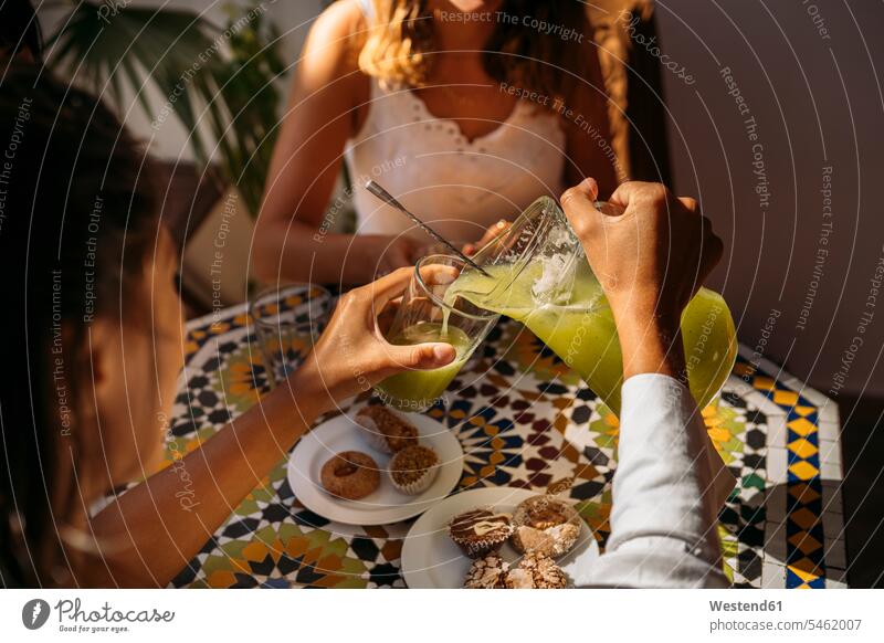 Woman serving lemonade to her friend in a Moroccan cafe human human being human beings humans person persons caucasian appearance caucasian ethnicity european 2