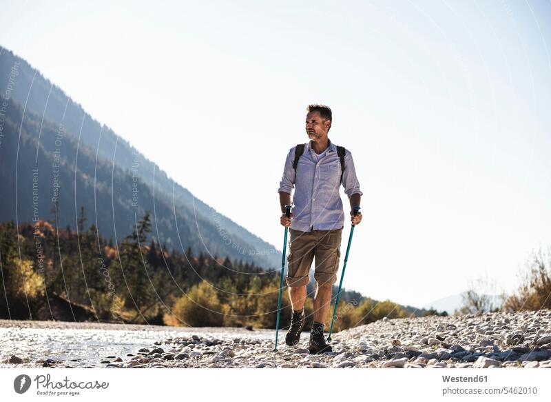 Austria, Alps, man on a hiking trip walking on pebbles along a brook caucasian caucasian appearance caucasian ethnicity european White - Caucasian mature men