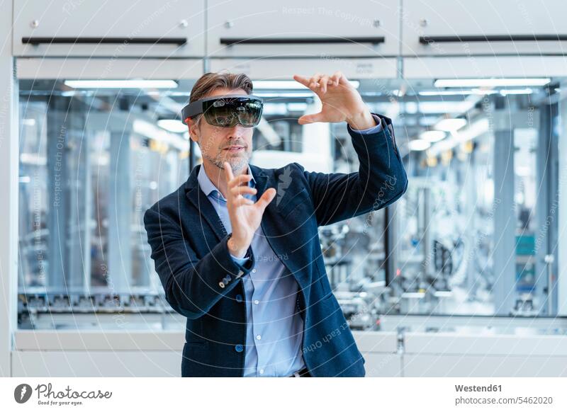 Businessman wearing AR glasses in a modern factory human human being human beings humans person persons caucasian appearance caucasian ethnicity european 1