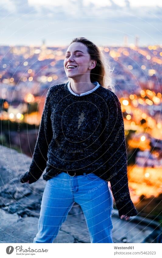 Happy young woman at dawn above the city, Barcelona, Spain human human being human beings humans person persons caucasian appearance caucasian ethnicity